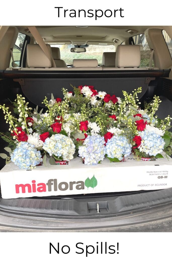 transporting vases of fresh flowers in the back of a car