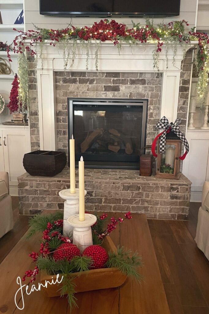 Christmas mantel with cedar garland and frosted red berries