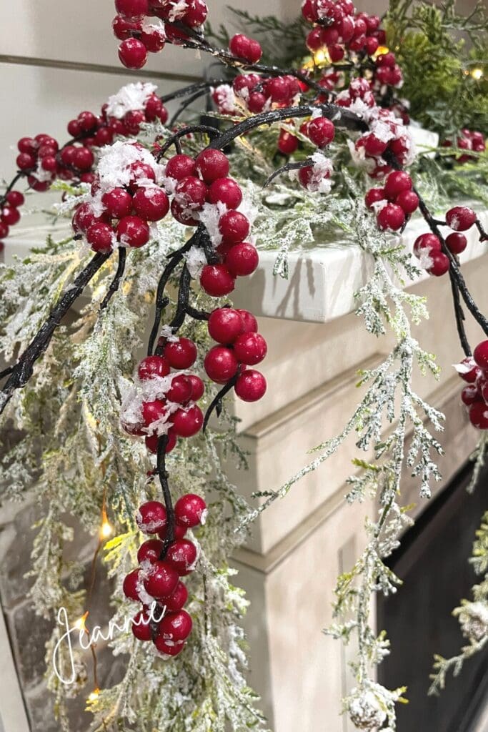 red berries and cedar garland for a Christmas mantel
