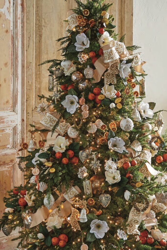 christmas tree with orange slices, magnolias, pomander balls, embroidered ribbon