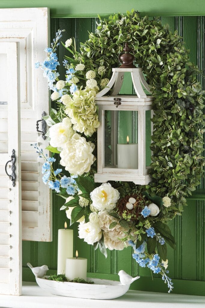 lantern hanging in an oval boxwood wreath