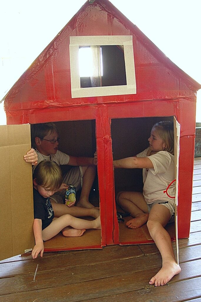 kids playing in the cardboard box barn