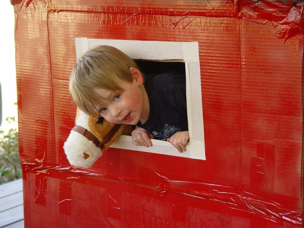 cut windows in the cardboard box barn
