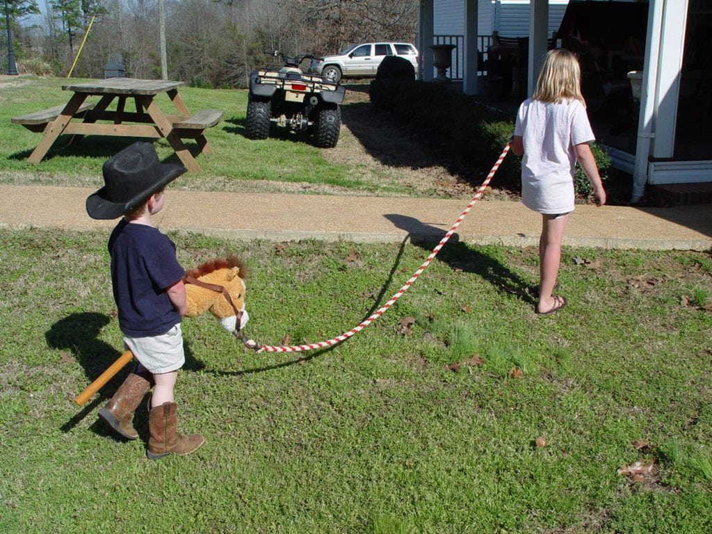 maggie leading matt on his stick horse
