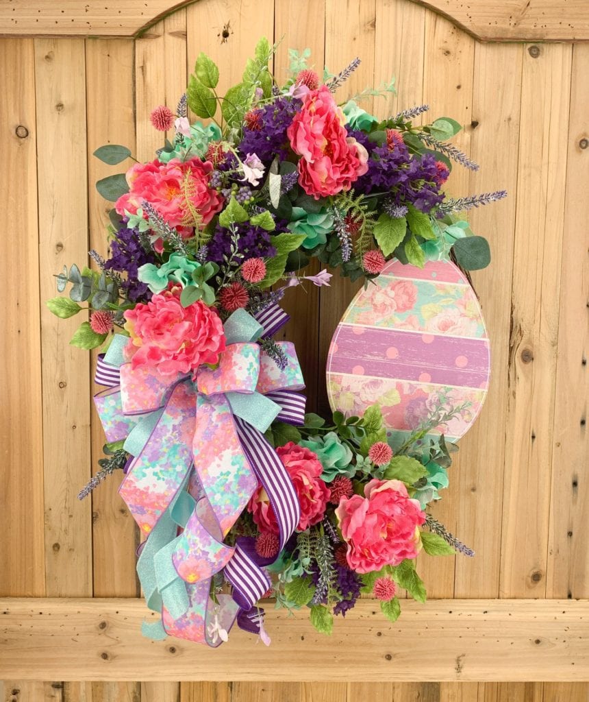 grapevine wreath with flowers and large easter egg sign