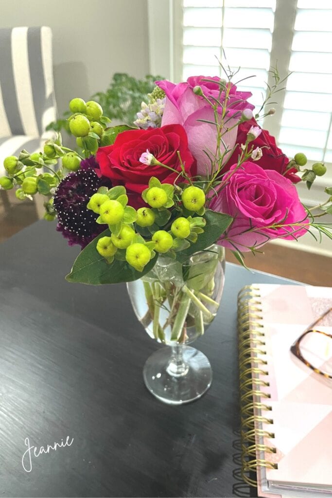 re-purpose fresh flowers by removed spent blooms and place in smaller vase with fresh water