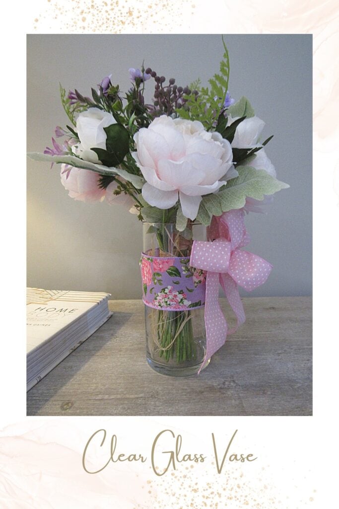 add ribbon and a bow to a clear vase of flowers