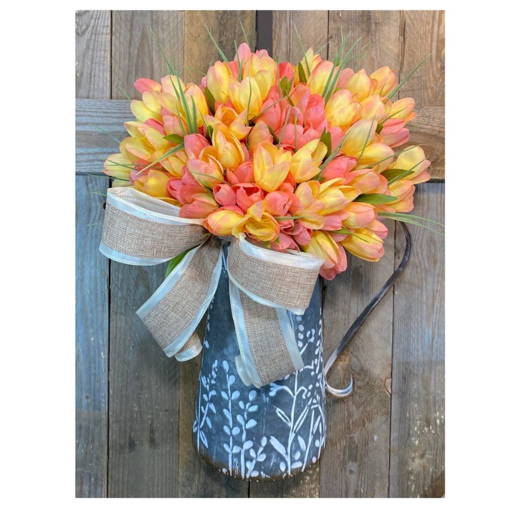 shades of peach faux tulips in a metal wall container as a door hanger