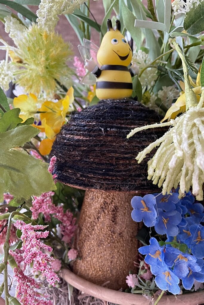 handmade mushroom with little bumblebee in a spring floral arrangement
