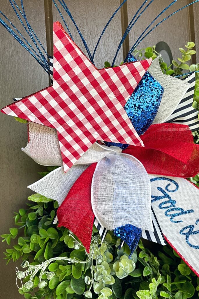 small funky patriotic bow on boxwood wreath