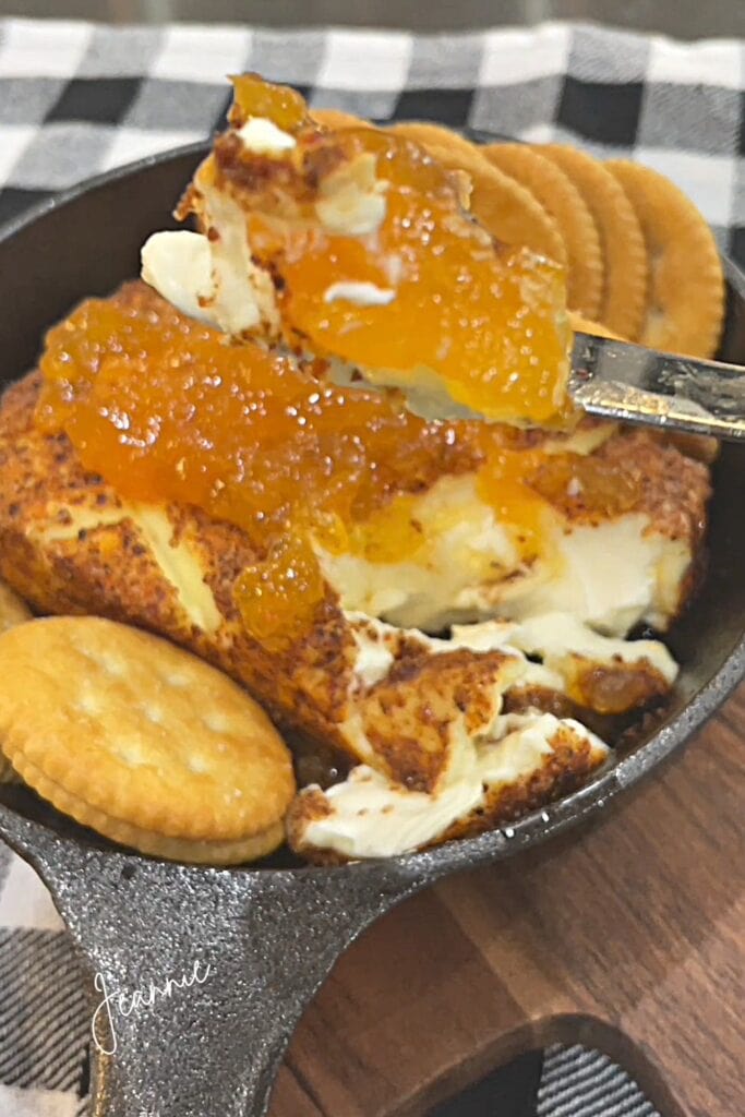 smoked cream cheese topped with apricot preserves and served with crackers