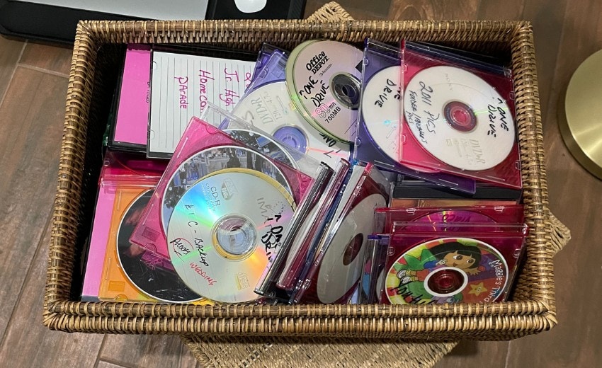 box of old CDs and DVDs