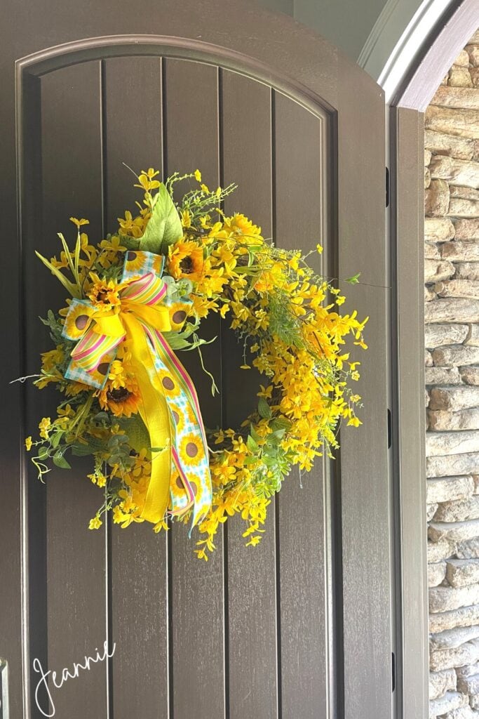 repurposed yellow forsythia wreath on my front door