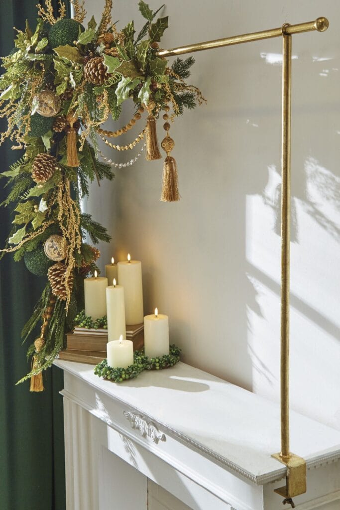 gold christmas decorations and pinecones on an over the table stand