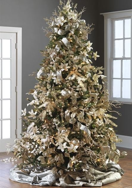silver, gold and champagne colored decorations on a green tree, metallic ribbons and tree skirt