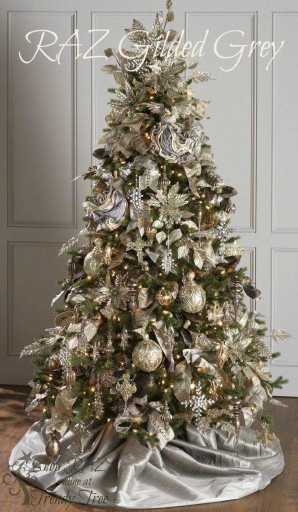 champagne, grey ornaments, gold balls, silver drop ornaments, gilded poinsettias on a christmas tree with silver skirt