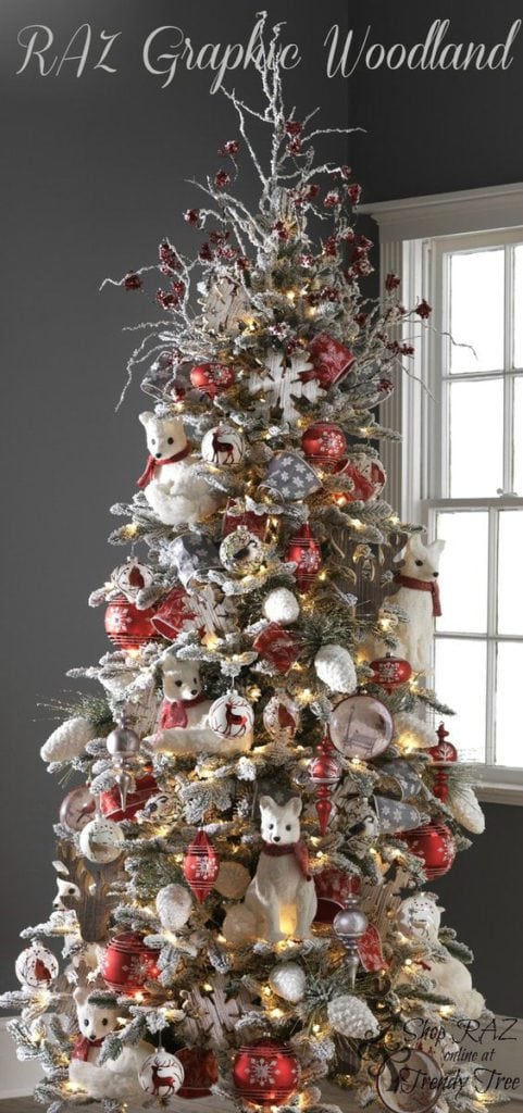 woodland christmas tree with white foxes, reindeer ornament, snowed pinecones, red birds and red finials