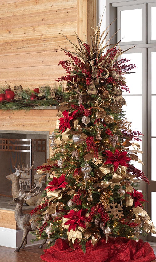 holiday lodge christmas tree, but elegant looking with rich red velvet poinsettias, wooden snowflakes, natural and gold ribbons