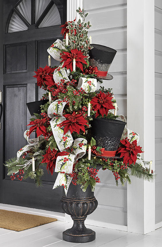 Potted Christmas tree with big black top hats, red berry sprays and ribbon