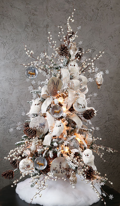 woodland tabletop tree with white feathered owls, deer ornaments, big pinecones and white berry picks