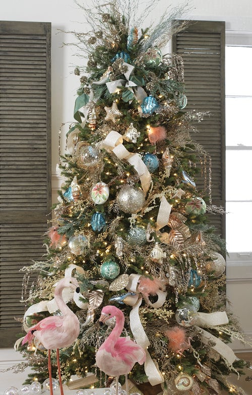 deck the shore beach style christms tree with sea green ornaments, clear glass ornaments, starfish, sandy ribbons, flamingo ornaments