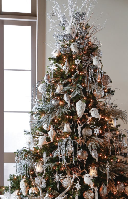 first snow tree with white feathered owls, bronze and copper ornaments, icey picks, snowy pinecones