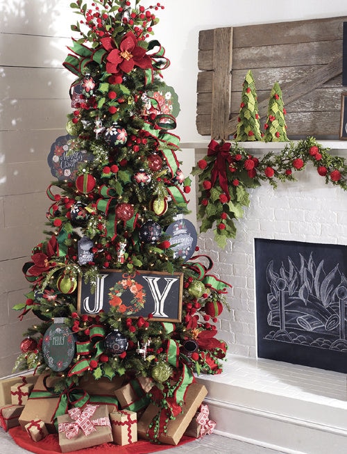 homespun holiday tree with red and green ribbons and ornaments, chalkboard style ornament and joy signs. Holly sprays and fuzzy ball garlands.