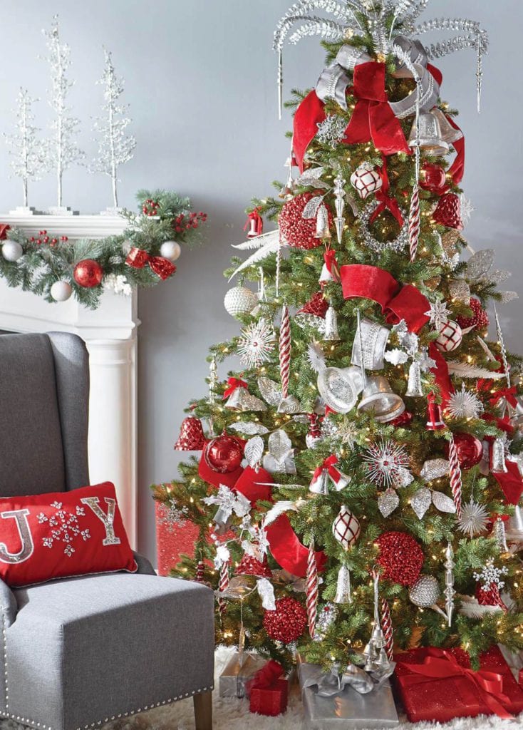 green christmas tree, red velvet ribbon, silvery ornaments, red berry balls, glittered silver ferns.