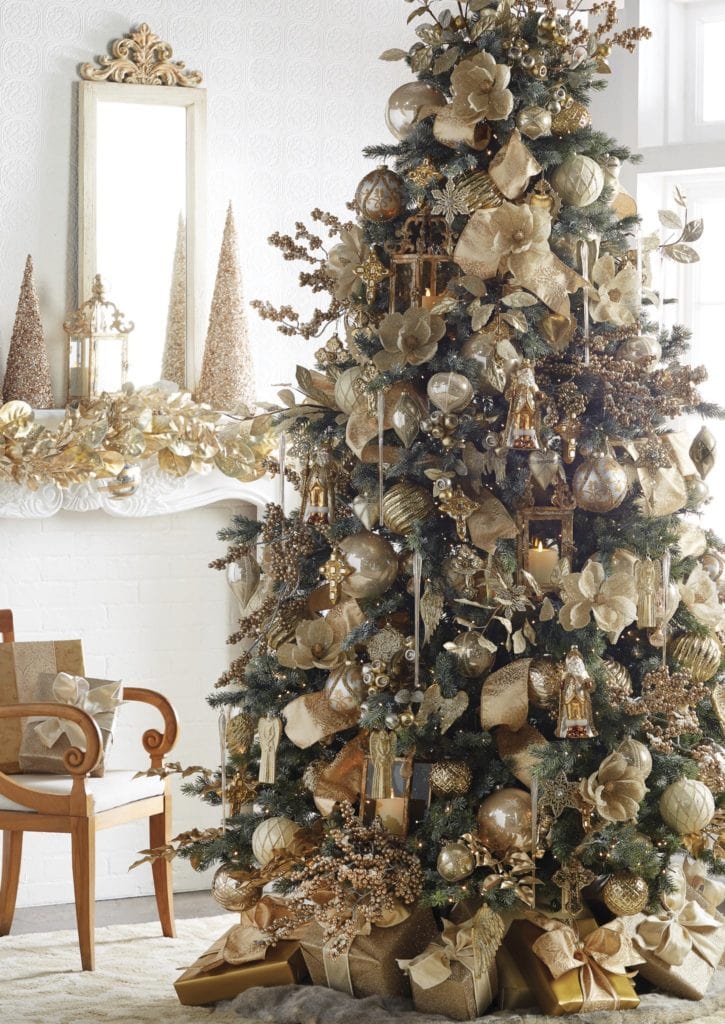 green pine tree with gold, champagne balls, finisial and icicles, golden poinsettias, burnished gold berry sprays, big gold bows, ornate ornaments