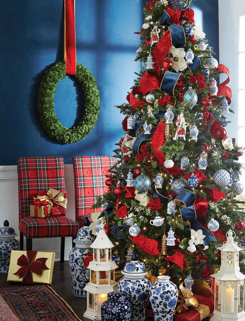 christmas tree with rich red velvet ribbons and rose clusters, royal blue or navy ribbon trimmed in gold, ginger jar style ornaments in blue and white, magnolia blooms, red balls and finials