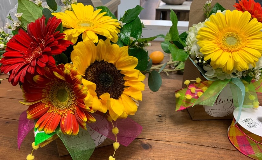 small fresh fall florals with huge pops of color with yellow and orange sunflowers, red and yellow daisies and hydrangeas