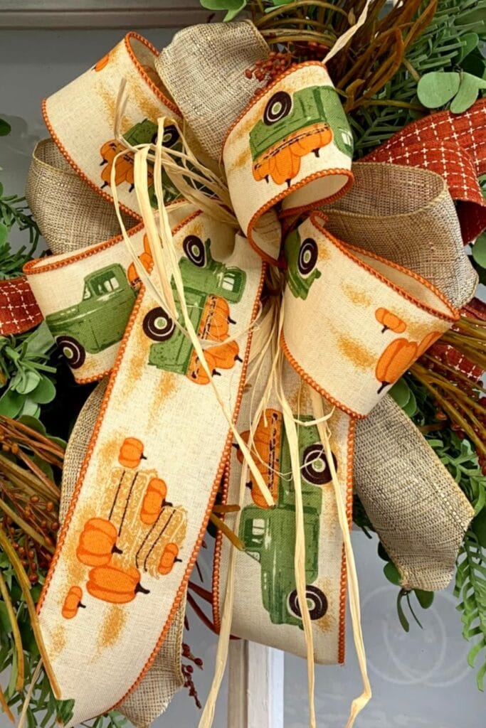 fall wreath bow using three ribbons and raffia, ribbon with green truck and pumpkins