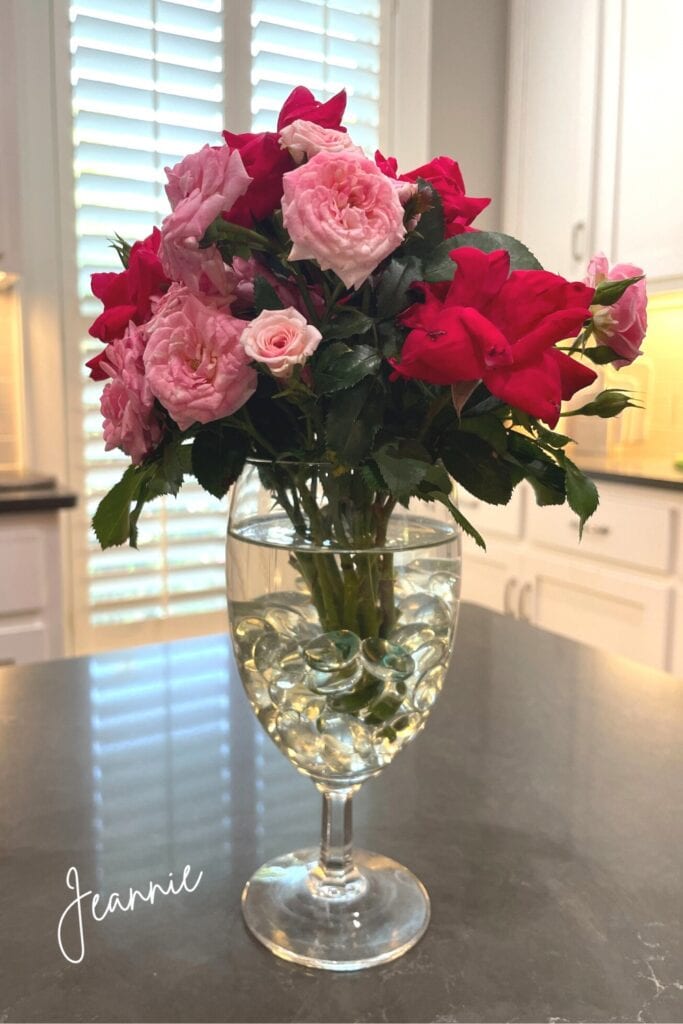 short stemmed roses in a glass