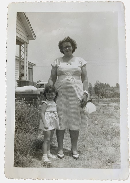my grandmother and me standing in the front yard