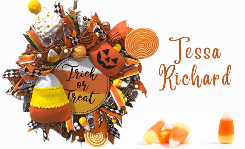 Halloween wreath with round trick or tree sign, plush candy corn, lollipops and candy corn picks