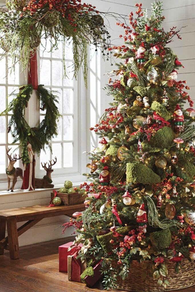 through the wood christmas tree with red berry picks, mossy balls, moss ribbon, gnome ornaments, window dressing and wreath