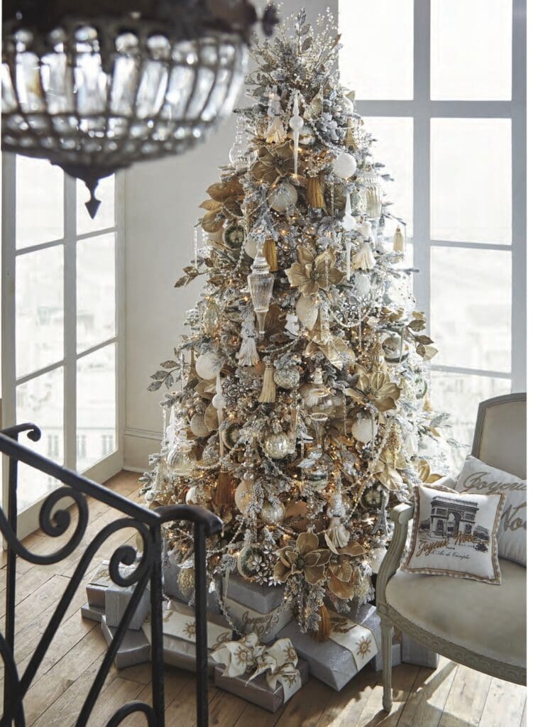 The City of Lights tree is another tree glowing in gold, silver, platinum, and white. They even carried the theme to the presents underneath the tree! Clear crystal beads, garlands, and ornaments adorn the tree. Huge gold and champagne Poinsettias encrusted with glitter really pack a wow factor. I love the combination of metallics. It tones down a brassy gold color and blends with pewter and silver. Frosted icicles and finials add to the elegance of the City of Lights tree.