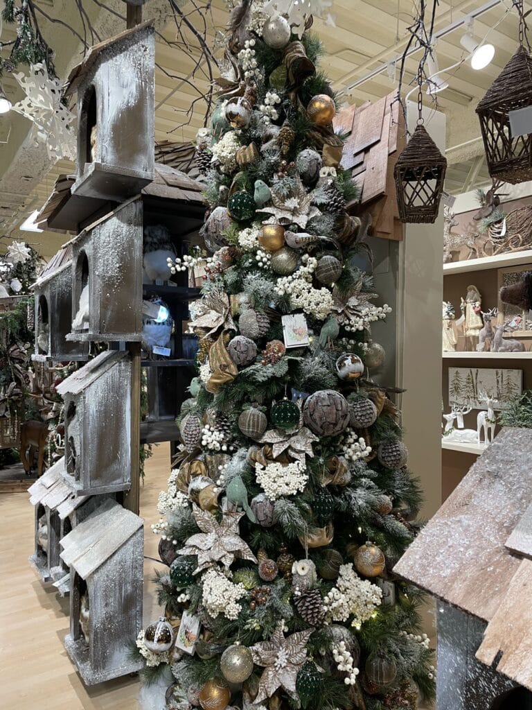 natural looking christmas tree with feathered birds, white berries, feathered balls, twigs, pinecones, muted shades of green and grey