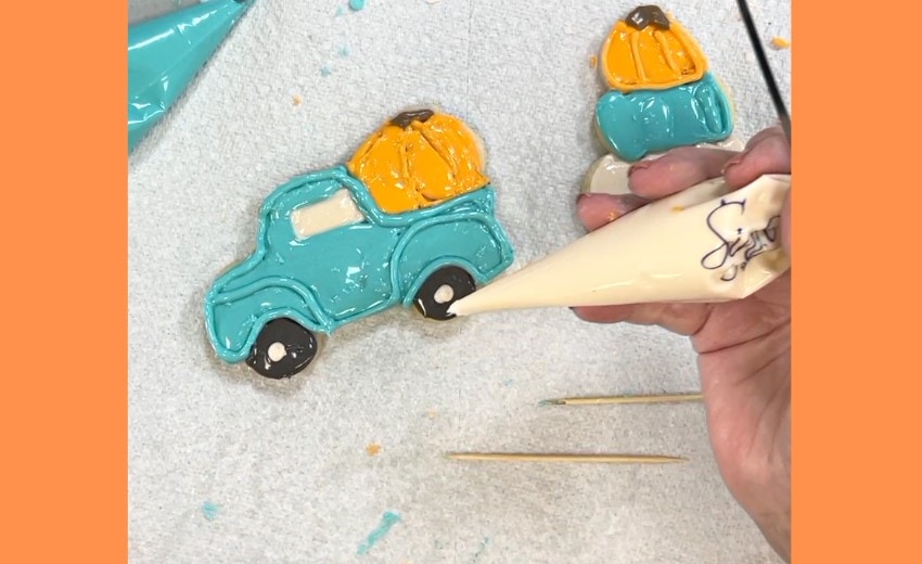 decorated sugar cookies pumpkin shape and truck with pumpkins