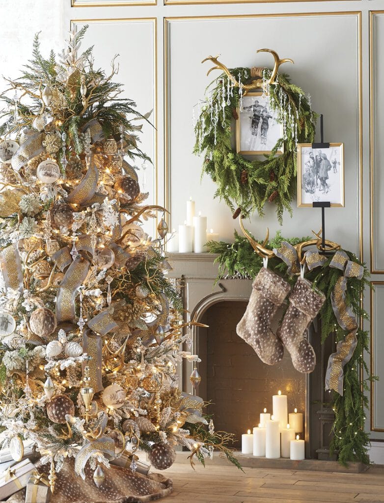 chalet tree with burnished pinecones, white glass pinecone ornaments, finials, kismets in champagne, gold and silver, snowflakes, clear crystal drop ornament and gilded antler ornaments. 