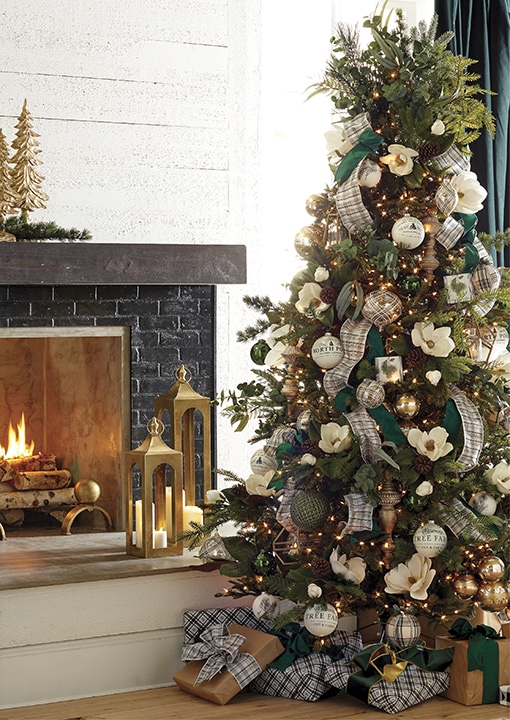 Green tree with creamy magnolias, plaid ribbon, gold and silver balls, green ornaments