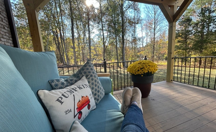 laying on a bed swing on the back porch