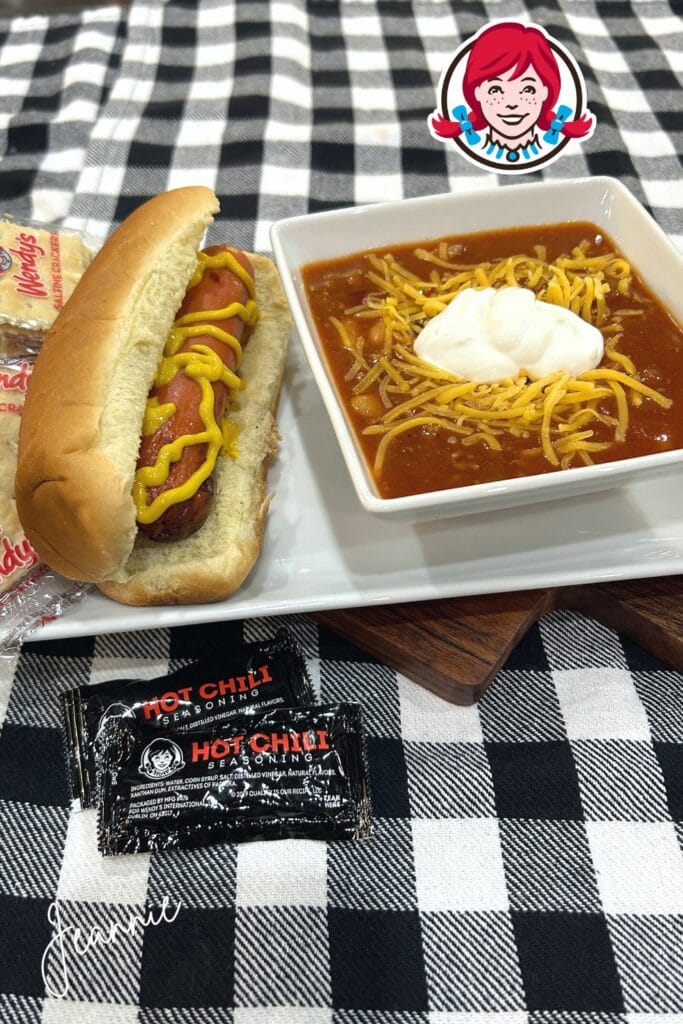 hot dog and chili with shredded cheese, sour cream, crackers