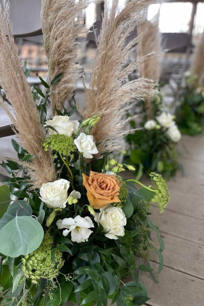 arrangement of roses and pampas grass