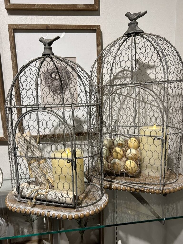 farmhouse-style lantern with rolled pages tied with raffia and battery candle, a tray of chick eggs with feathers