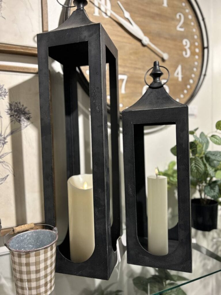 black metal lantern with white candles