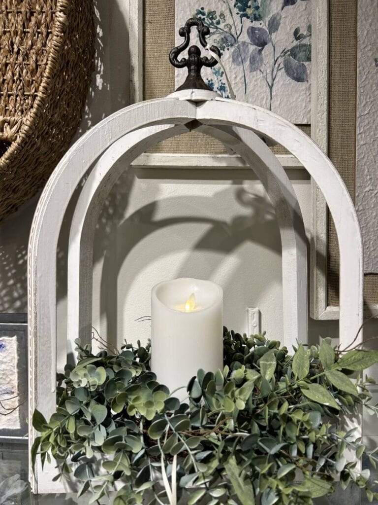 white wood lantern with eucalyptus greenery and candle