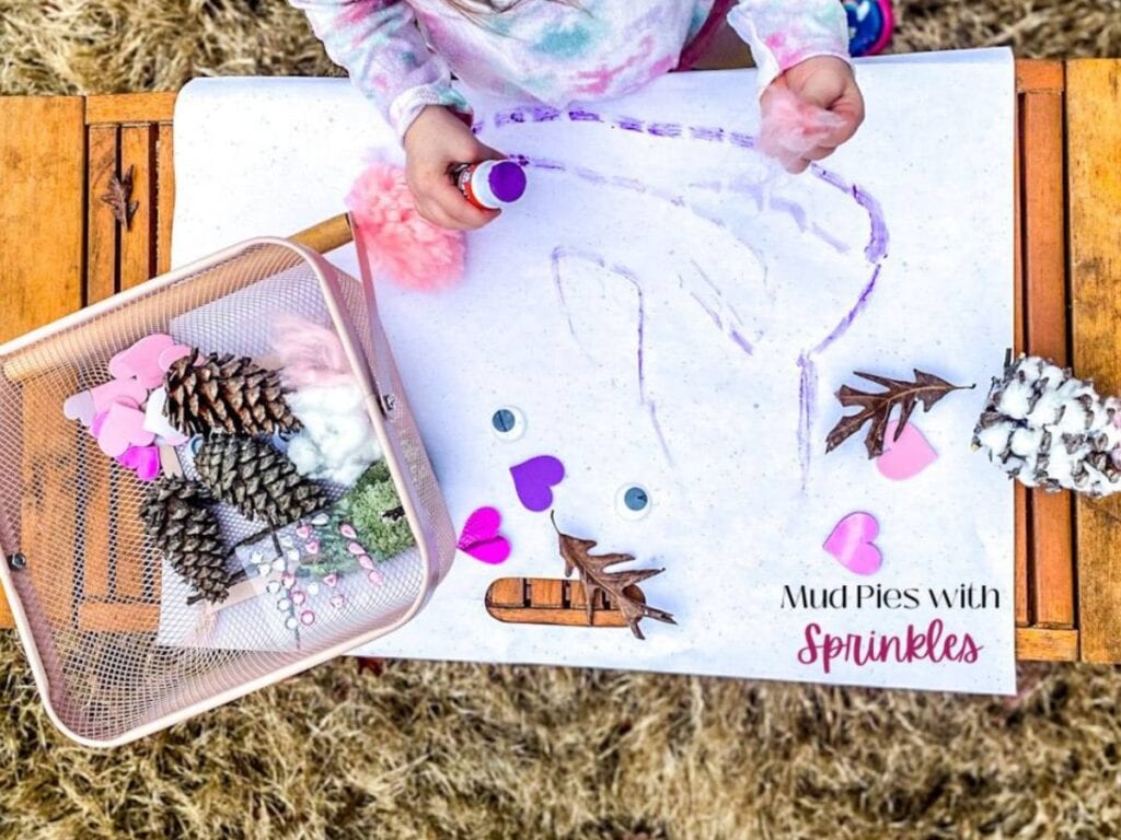 small child making an owl pine cone for valentine