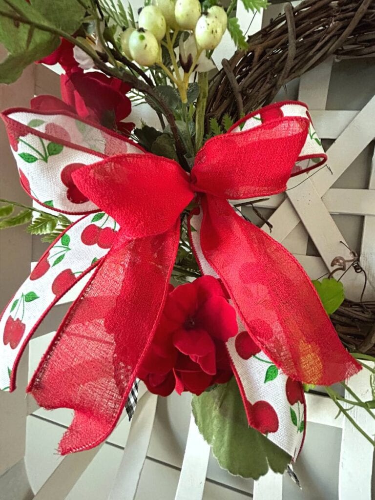 simple bow made with repurposed ribbon for a spring floral decoration in a tobacco basket