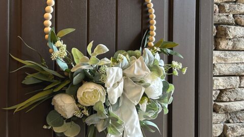 wood bead wreath with flowers and bow